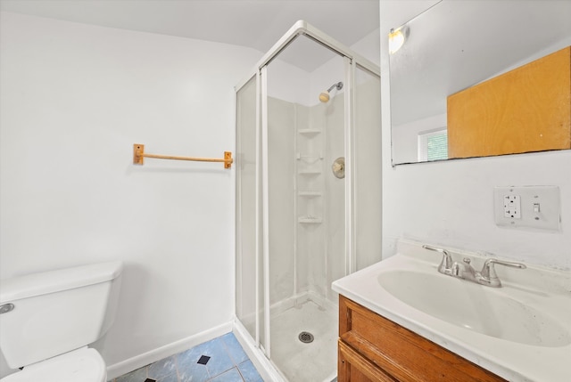 bathroom featuring vanity, tile patterned flooring, toilet, and walk in shower