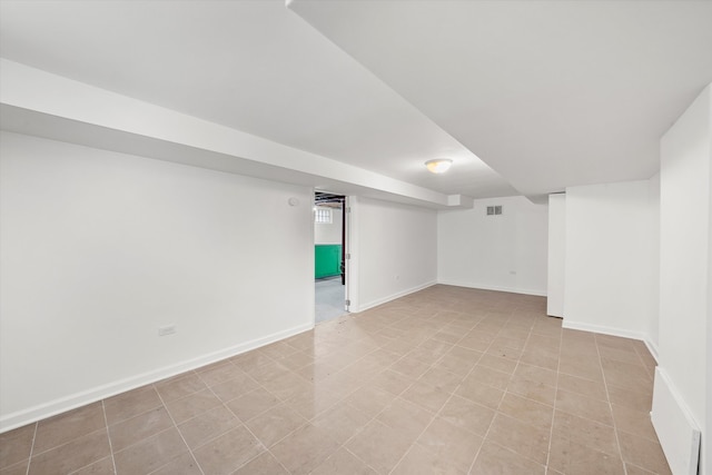 basement with light tile patterned flooring