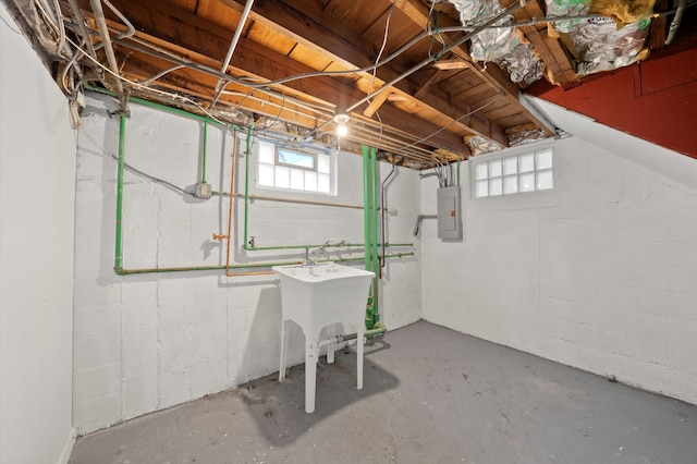 basement featuring electric panel and sink