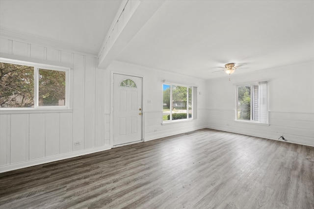 interior space with beam ceiling, dark hardwood / wood-style floors, and ceiling fan