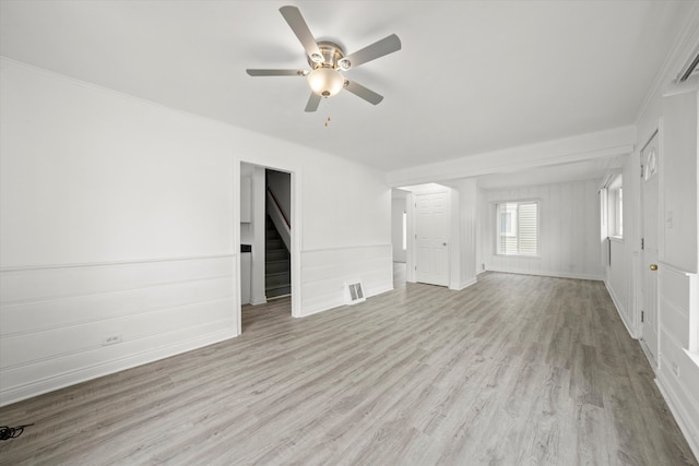 unfurnished living room featuring ceiling fan, ornamental molding, and light hardwood / wood-style flooring