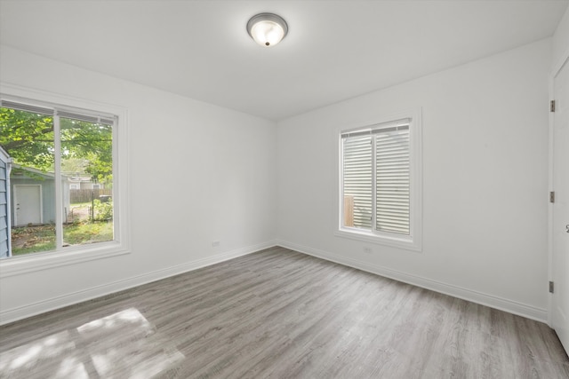 spare room featuring a wealth of natural light and light wood-type flooring