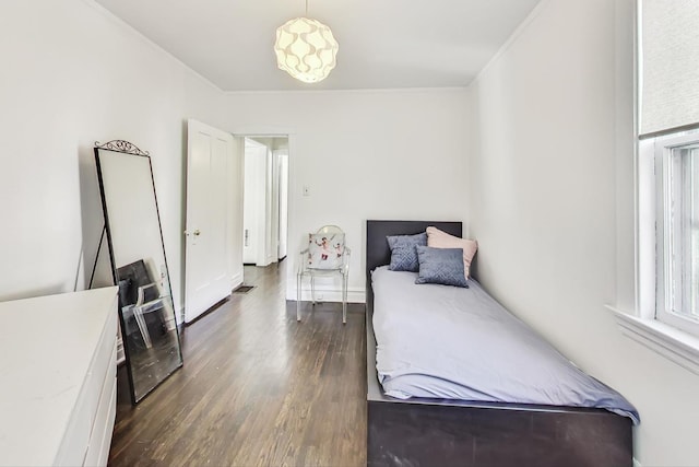 bedroom with dark hardwood / wood-style flooring