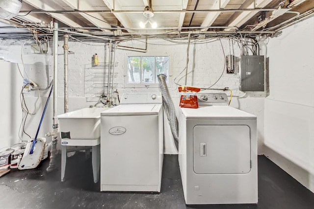 clothes washing area with sink, electric panel, and washer and clothes dryer