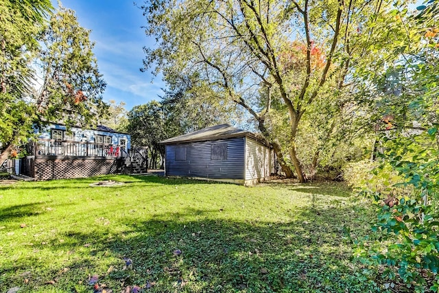 view of yard with a wooden deck and a storage unit