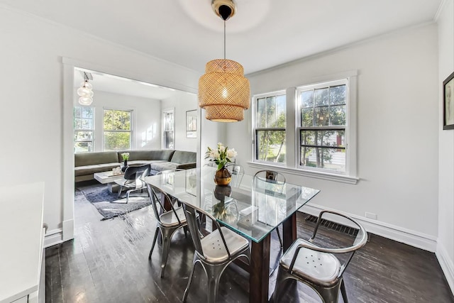 dining area with crown molding and dark hardwood / wood-style floors