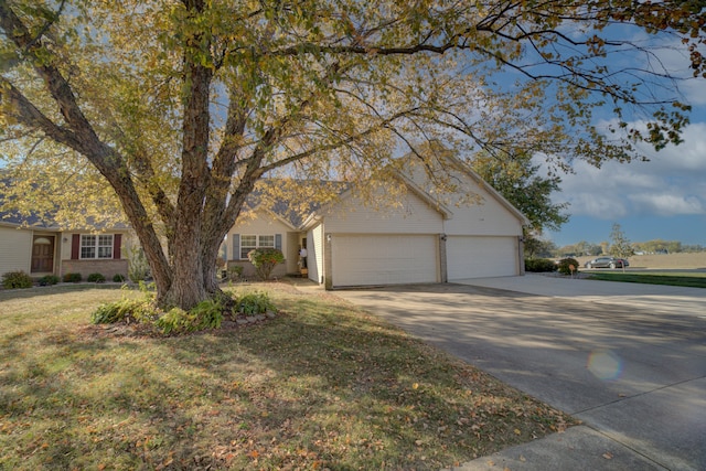 view of front of property with a front yard and a garage