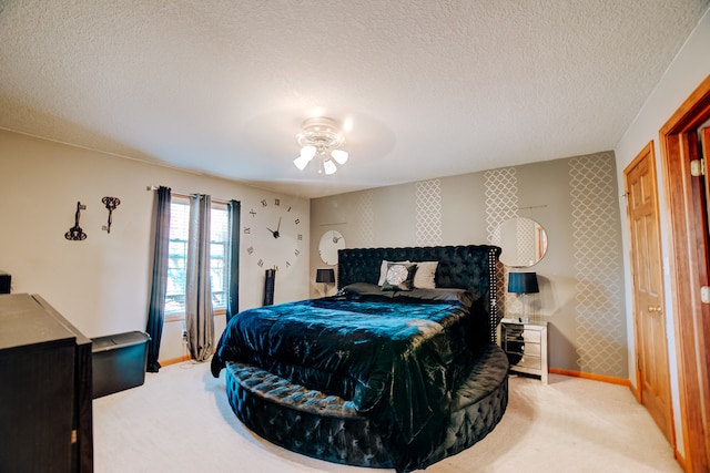 bedroom featuring a textured ceiling, carpet flooring, and ceiling fan