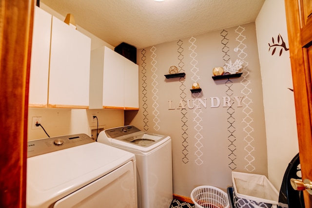 laundry room with independent washer and dryer, a textured ceiling, and cabinets