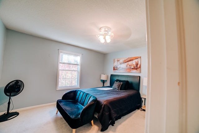 bedroom with a textured ceiling and carpet flooring