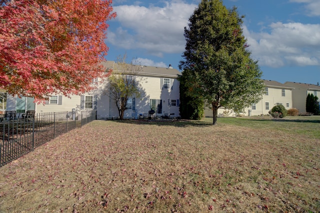 rear view of property with a yard