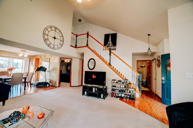 living room featuring hardwood / wood-style floors, high vaulted ceiling, and ceiling fan