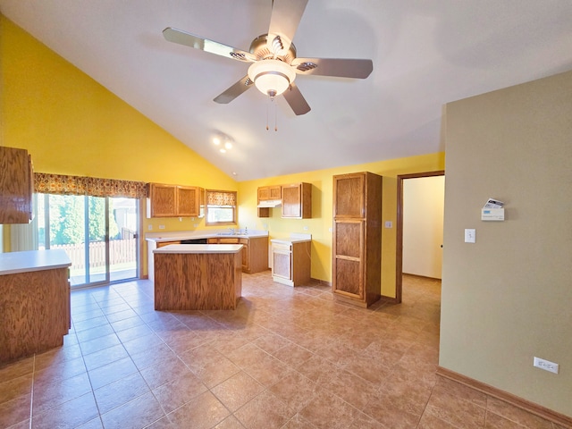 kitchen featuring sink, a center island, light tile patterned floors, high vaulted ceiling, and ceiling fan