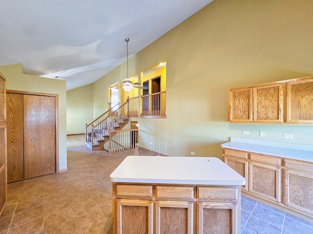 kitchen featuring ceiling fan, decorative light fixtures, and a kitchen island