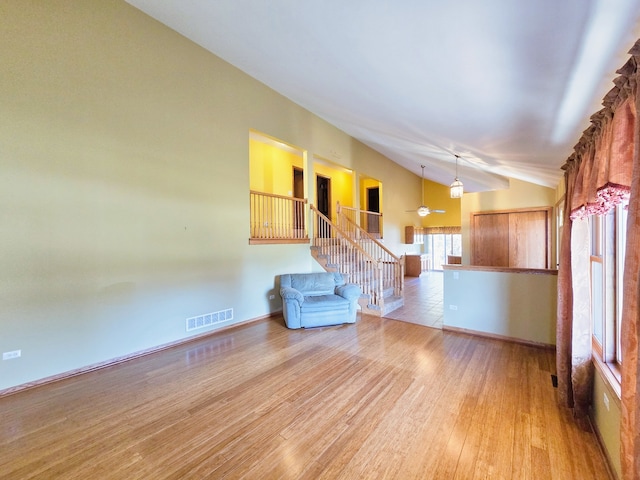 interior space with vaulted ceiling and light hardwood / wood-style flooring