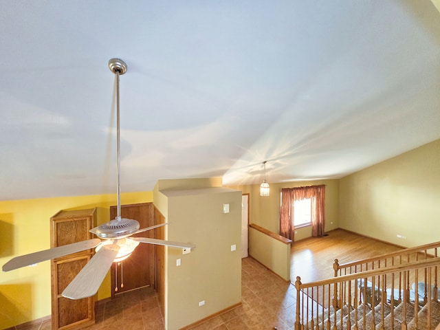 interior space featuring vaulted ceiling and ceiling fan