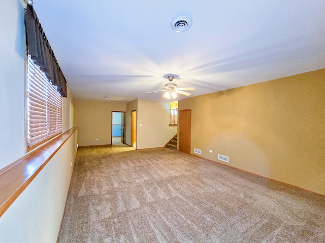 unfurnished room with light carpet and ceiling fan