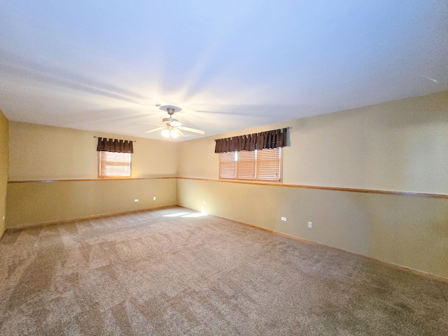 carpeted empty room featuring ceiling fan