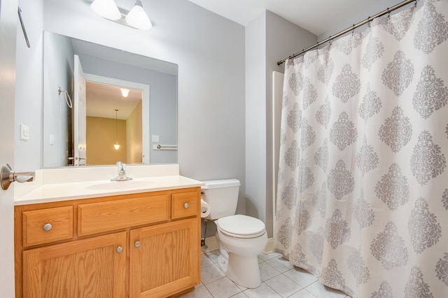 bathroom with vanity, a shower with shower curtain, toilet, and tile patterned floors