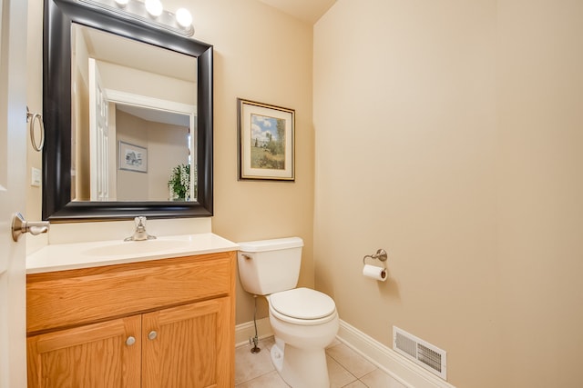 bathroom with vanity, toilet, and tile patterned floors