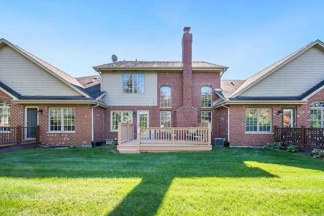 back of property with central air condition unit, a wooden deck, and a lawn