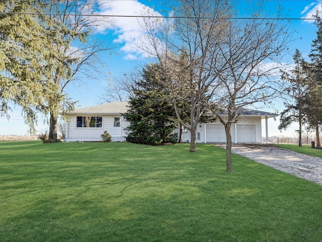 ranch-style house with a garage and a front lawn