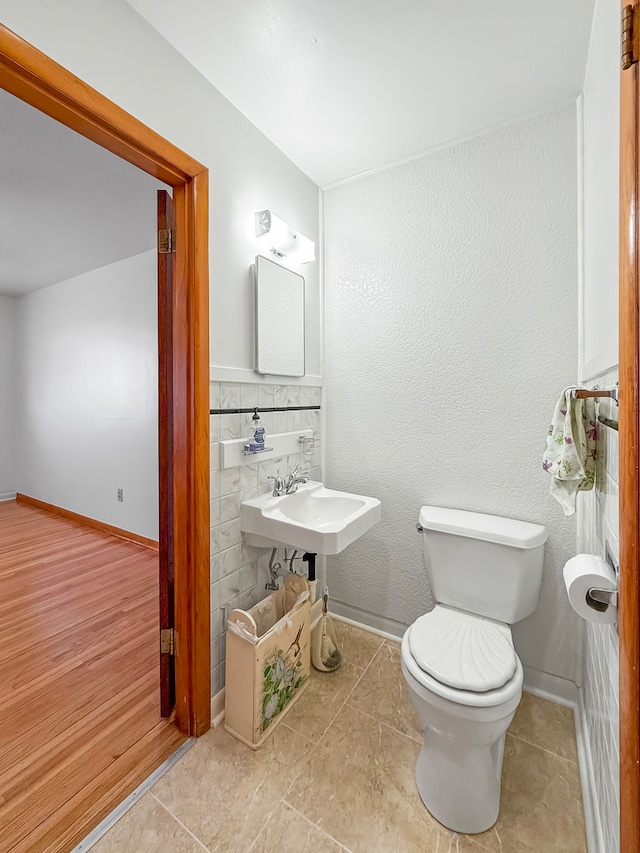 bathroom with tile patterned flooring, toilet, and sink