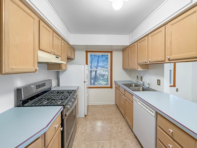 kitchen with gas stove, light brown cabinetry, sink, and dishwasher