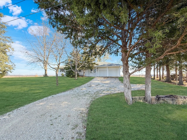 view of front of house featuring a garage and a front yard