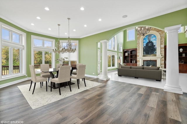 dining area with crown molding, hardwood / wood-style flooring, and a chandelier