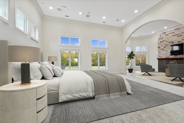 carpeted bedroom with a high ceiling and crown molding