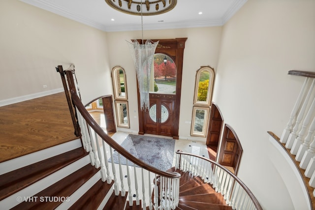 foyer featuring ornamental molding and hardwood / wood-style floors