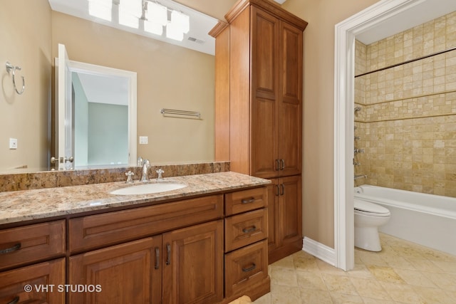 full bathroom featuring vanity, toilet, and tiled shower / bath combo