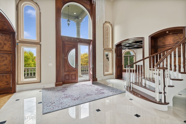 foyer entrance featuring a towering ceiling