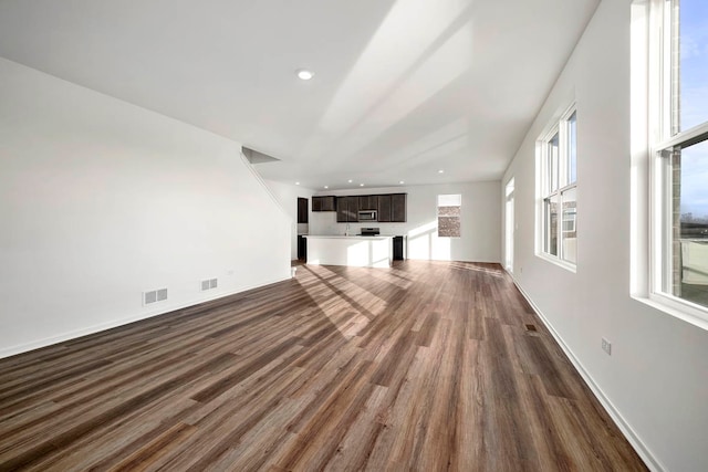 unfurnished living room with dark hardwood / wood-style floors