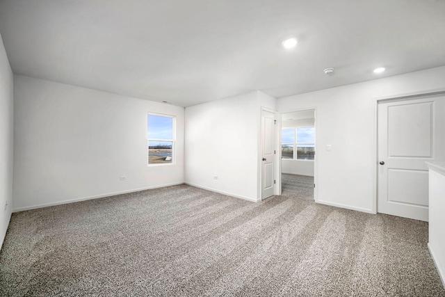 carpeted empty room with a wealth of natural light