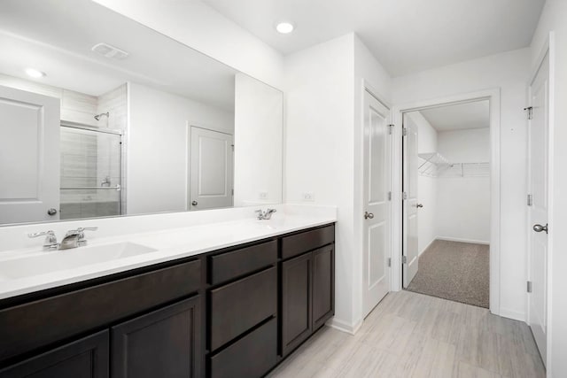 bathroom with vanity and an enclosed shower