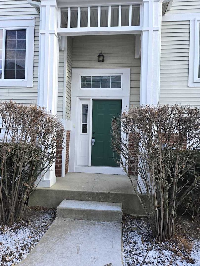 view of snow covered property entrance