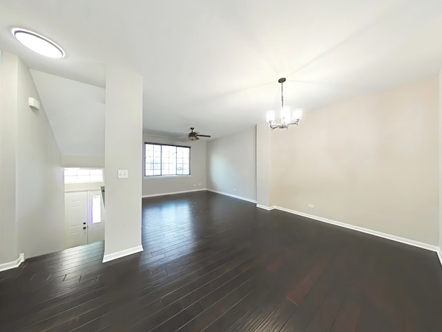 unfurnished room with ceiling fan with notable chandelier and dark hardwood / wood-style floors