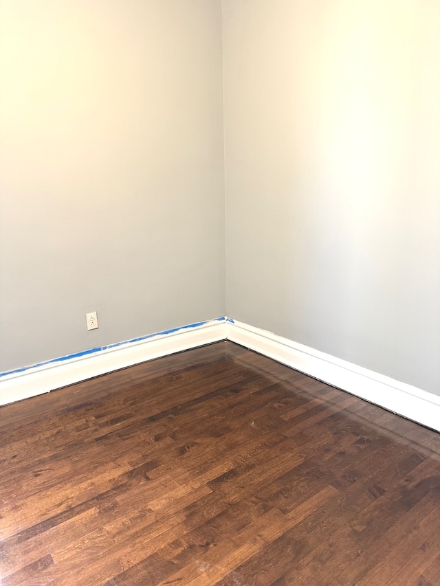 spare room featuring dark wood-type flooring