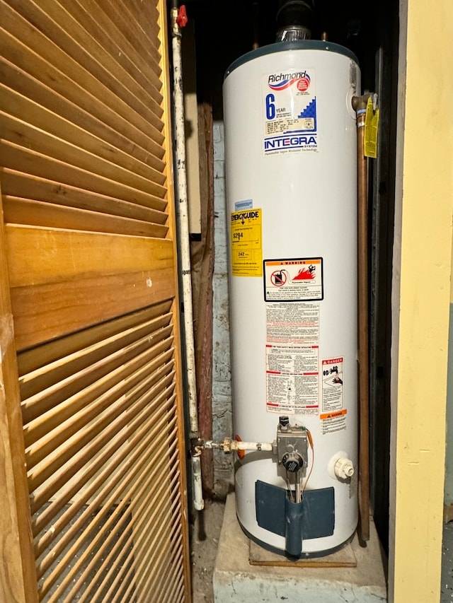 utility room featuring gas water heater