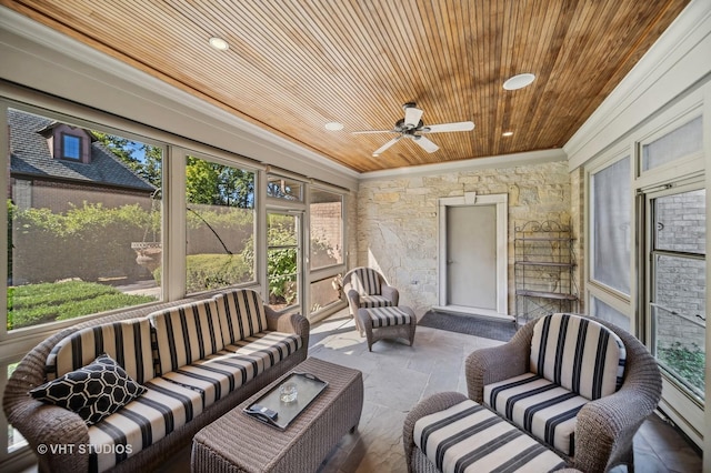 sunroom featuring a ceiling fan, outdoor lounge area, and a healthy amount of sunlight