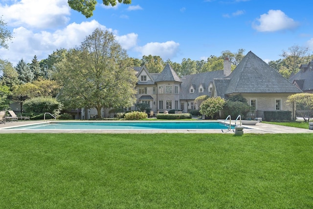 outdoor pool with a yard and a patio