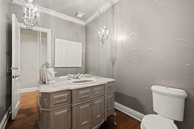 half bathroom with baseboards, toilet, vanity, and wood finished floors