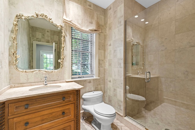 bathroom with vanity, toilet, and a stall shower