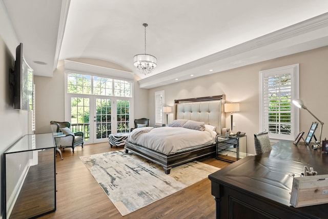 bedroom with french doors, vaulted ceiling, baseboards, a notable chandelier, and wood finished floors
