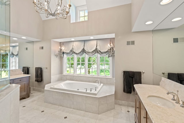 bathroom featuring a garden tub, vanity, visible vents, and baseboards