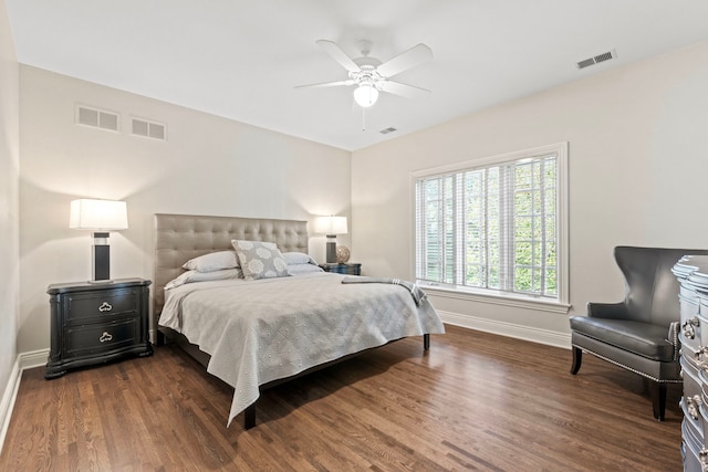bedroom featuring baseboards, dark wood-type flooring, and visible vents