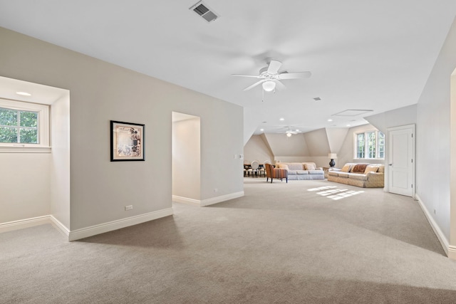 unfurnished living room with baseboards, a ceiling fan, carpet flooring, and visible vents