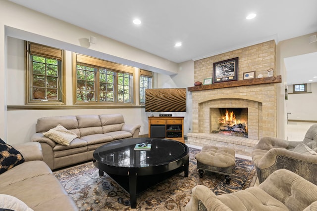 living area featuring recessed lighting, a healthy amount of sunlight, visible vents, and a fireplace
